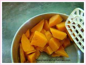 use a masher to mash boiled yams