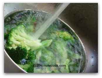 Refresh cooked broccoli under running cold tap water