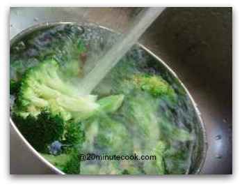 Refresh cooked broccoli under running cold tap water Refresh cooked broccoli under running cold tap water