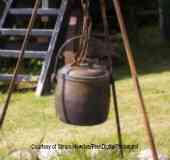 Camping cooking recipes in a one pot dutch oven hanging from a tripod
