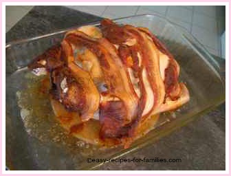 the easy roast chicken out of the oven covered with crisp bacon strips