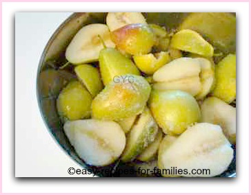 a bowl of halved pears coated with sugar