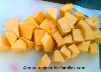 Diced pumpkin pieces in a saucepan