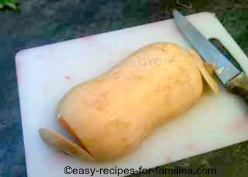 The first step in how to make pumpkin puree is to trim off the outer skin