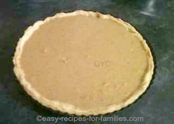 Pastry shell for this Low fat pumpkin pie recipe filled with pie filling ready for baking 