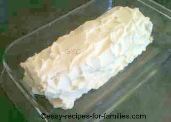  Pumpkin roll recipe finished with a thick layer of whipped cream 