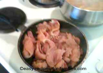 Bacon being fried in a fry pan 