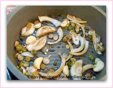 Onions and garlic with seaoning at the base of a non-stick cake mold