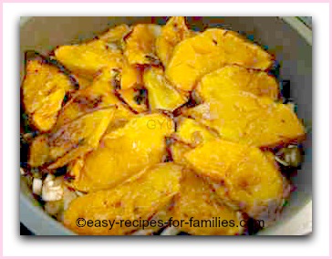 roasted pumpkin slices arranged on the base of a cake mold