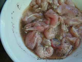 Chicken pieces being marinaded for his easy coq au vin