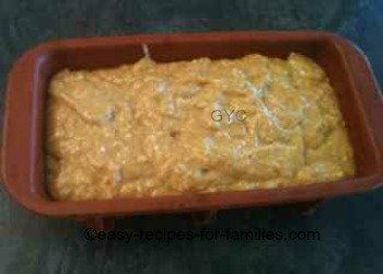 The smooth bread batter poured into the loaf tin