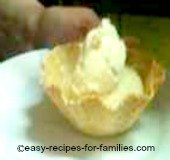 A scoop of homemade ice cream in a waffle cup