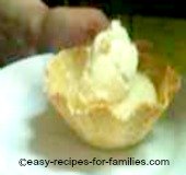 A scoop of homemade ice cream in a waffle cup