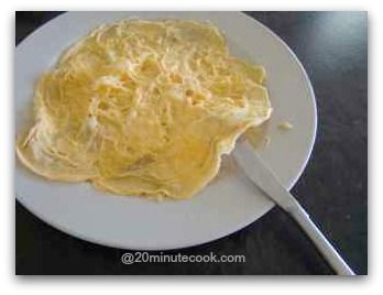 Run a blunt knife under the omelette to lift it from the plate
