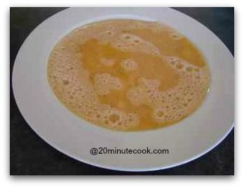 Beaten eggs poured into a shallow hollowed dinner plate