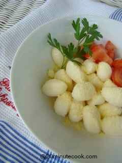 Gnocchi served in a bowl with grated parmesan cheese. Learn how to cook gnocchi