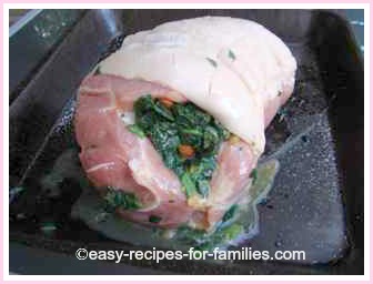 roll of roast pork stuffed with spinach and almonds