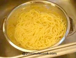 Spaghetti draining in a colander