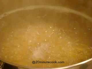 Spaghetti cooking in rapidly boiling water