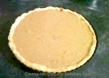Low fat pumpkin pie filling poured into the pastry shell ready for baking